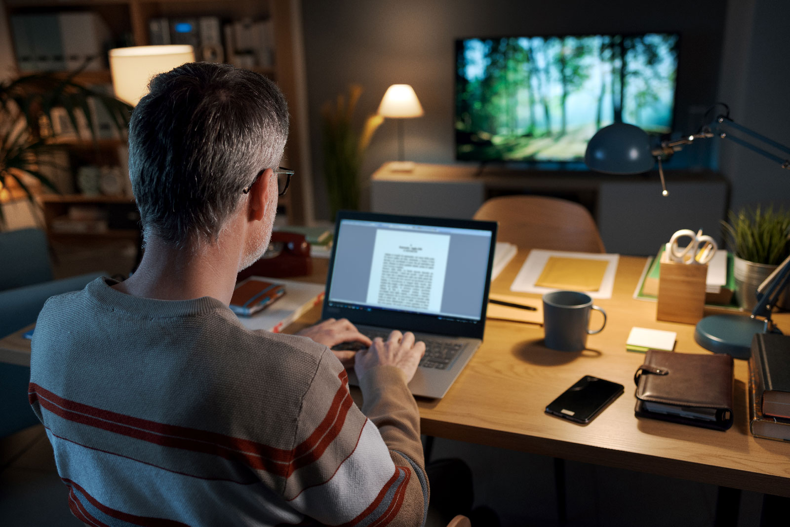 Image of an author writing at a desk